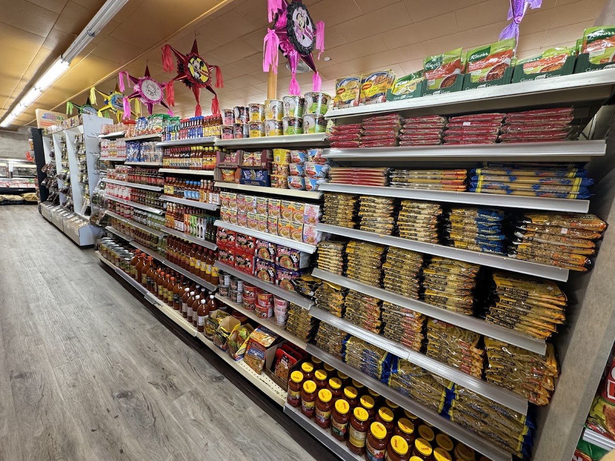 Grocery aisle at Julissa's Meat Market with piñatas hanging overhead